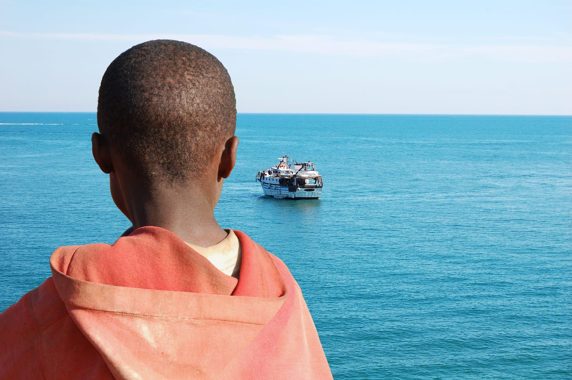 Refugee looking out to sea